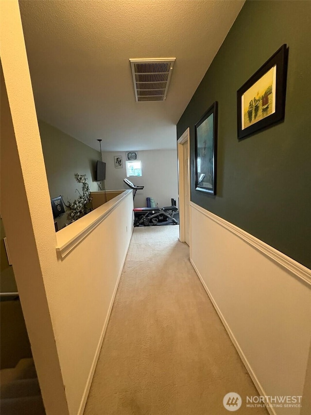 corridor with carpet floors and visible vents