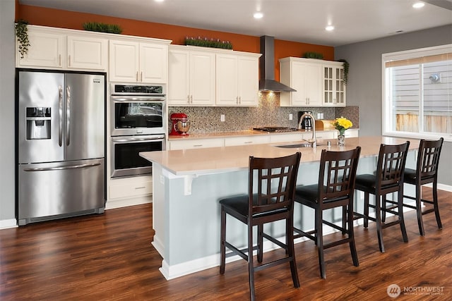 3908 187th Pl SE, Bothell, WA 98012 - kitchen featuring appliances with stainless steel finishes, a sink, wall chimney range hood, recessed lighting, and tasteful backsplash