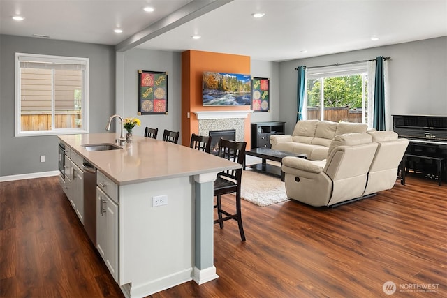3908 187th Pl SE, Bothell, WA 98012 - kitchen featuring a sink, a kitchen bar, open floor plan, a kitchen island with sink, and recessed lighting