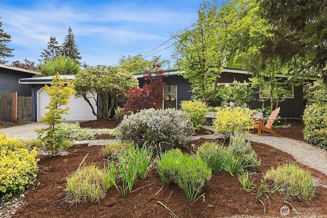 view of yard featuring fence and an attached garage
