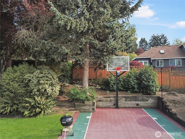 view of basketball court with fence