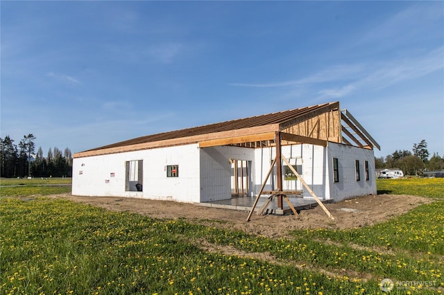 34 Van Dyken Dr, Sequim, WA 98382 - back of house featuring a yard, concrete block siding, and metal roof