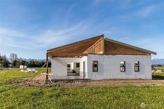34 Van Dyken Dr, Sequim, WA 98382 - back of property with a mountain view, concrete block siding, and a patio