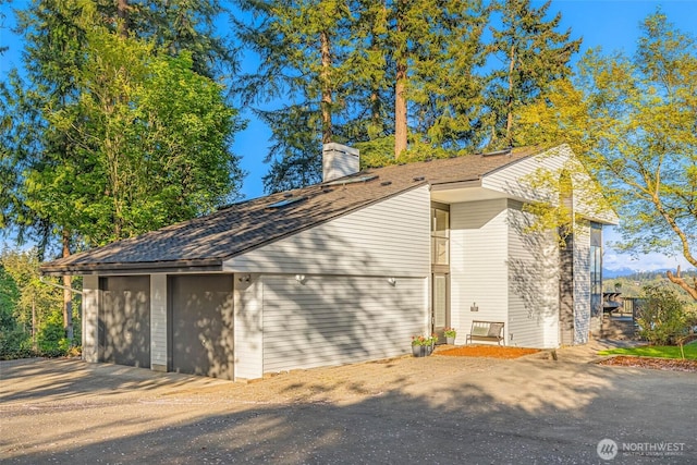 11324 83rd Pl NE, Kirkland, WA 98034 - view of property exterior with a shingled roof, a chimney, and a garage