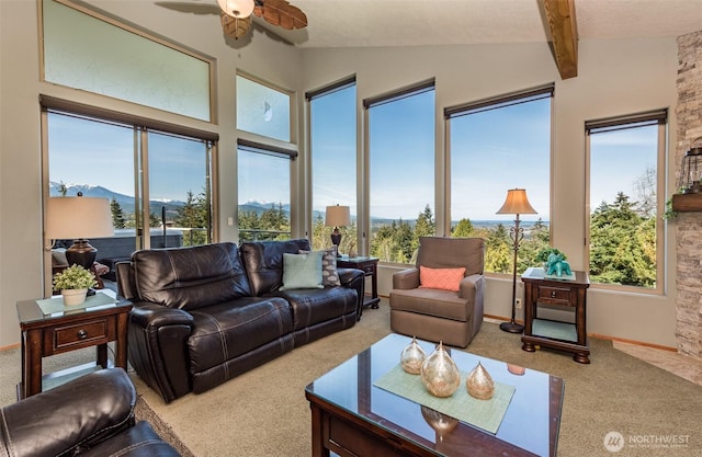 1573 Doe Run Rd, Sequim, WA 98382 - living area with a ceiling fan, carpet flooring, vaulted ceiling with beams, and plenty of natural light