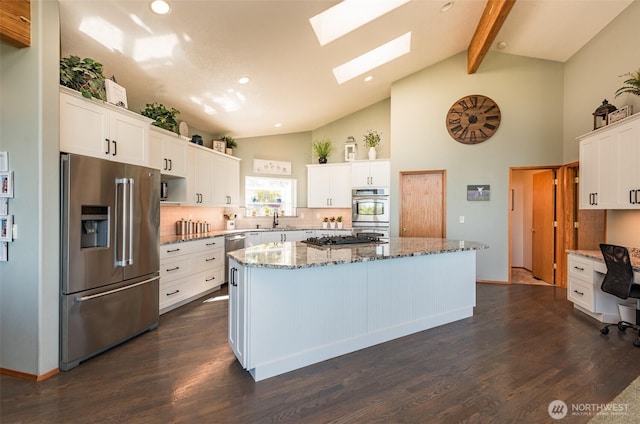 1573 Doe Run Rd, Sequim, WA 98382 - kitchen with white cabinets, stainless steel appliances, a sink, a center island, and high vaulted ceiling