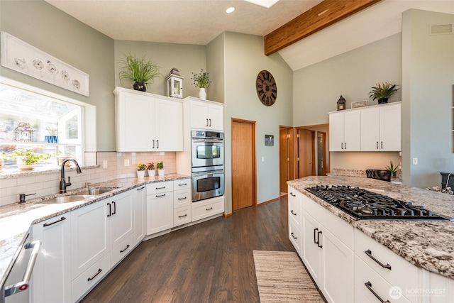 1573 Doe Run Rd, Sequim, WA 98382 - kitchen featuring high vaulted ceiling, a sink, stainless steel double oven, black gas cooktop, and visible vents