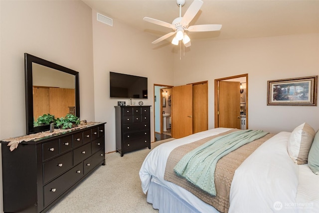 1573 Doe Run Rd, Sequim, WA 98382 - bedroom featuring high vaulted ceiling, connected bathroom, ceiling fan, light carpet, and visible vents