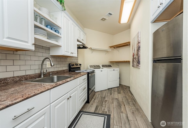 1573 Doe Run Rd, Sequim, WA 98382 - washroom with washer and clothes dryer, visible vents, a sink, and light wood finished floors