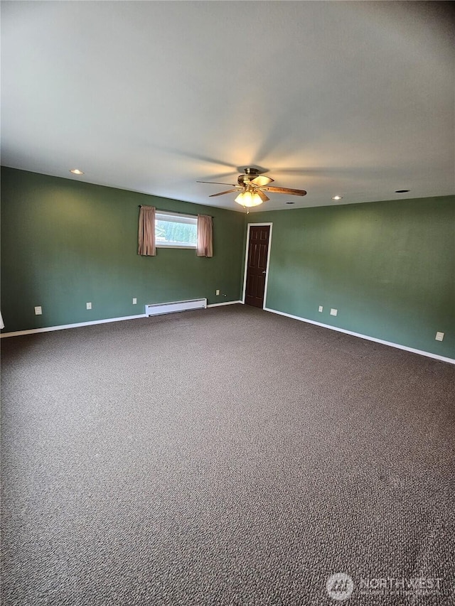 8 Calder Rd, Elma, WA 98541 - empty room featuring baseboard heating, ceiling fan, baseboards, and dark carpet