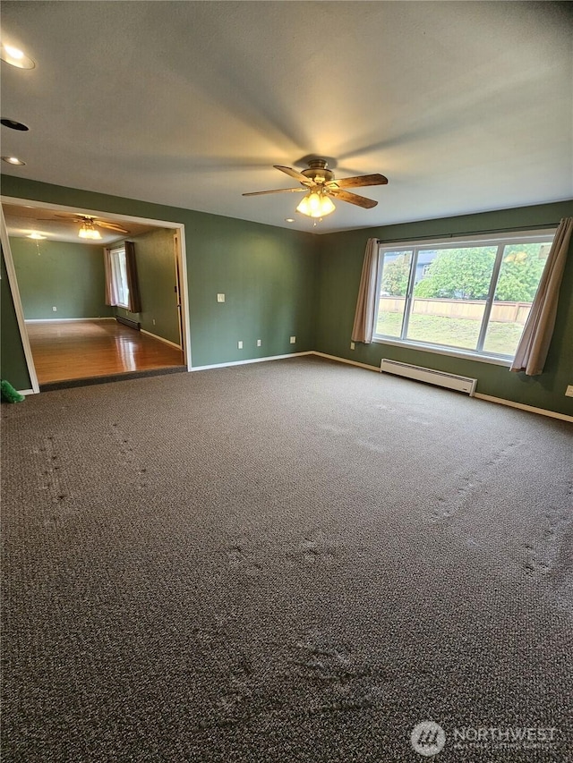8 Calder Rd, Elma, WA 98541 - empty room featuring a baseboard heating unit, ceiling fan, carpet, and baseboards