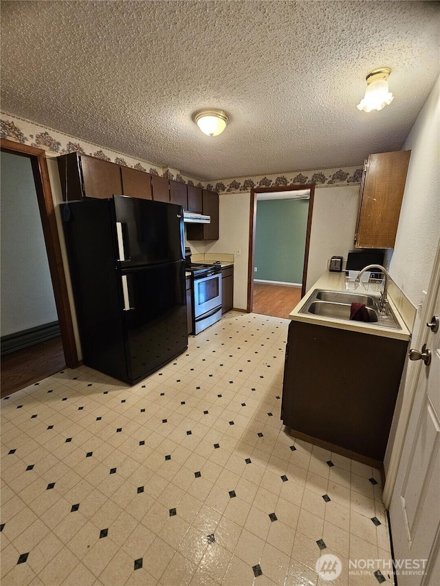 8 Calder Rd, Elma, WA 98541 - kitchen featuring stainless steel electric stove, freestanding refrigerator, a sink, light countertops, and a textured ceiling