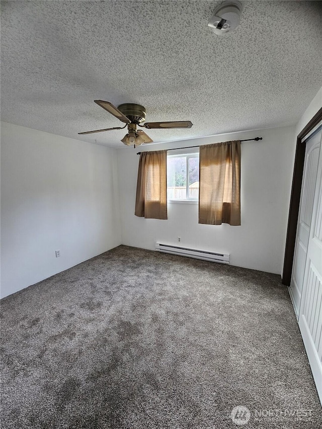 8 Calder Rd, Elma, WA 98541 - unfurnished bedroom featuring a baseboard radiator, carpet, a textured ceiling, and a ceiling fan