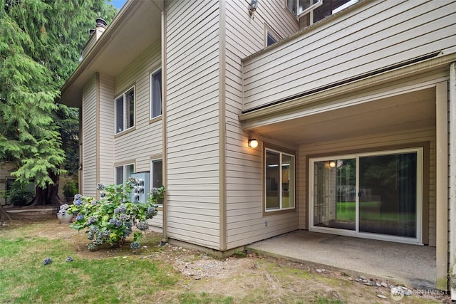 view of side of home featuring a patio area