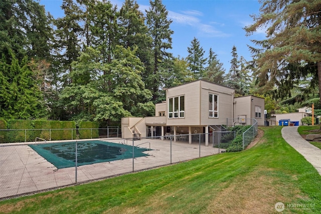 view of pool featuring a lawn, fence, a patio area, and stairway