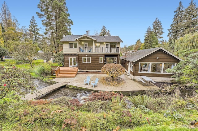 back of house featuring a patio, a balcony, and a deck