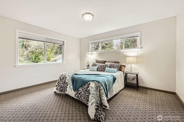 carpeted bedroom featuring baseboards and multiple windows