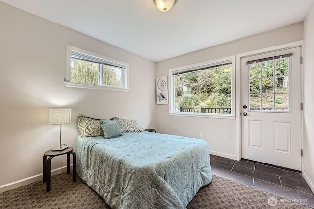 bedroom with baseboards and tile patterned floors