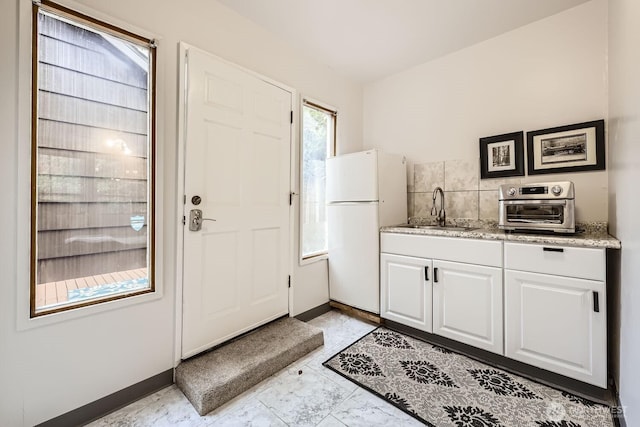 entryway with baseboards and a toaster
