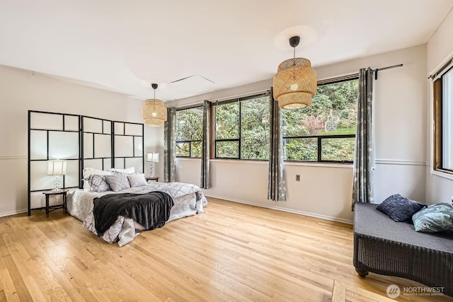 bedroom with baseboards and wood finished floors