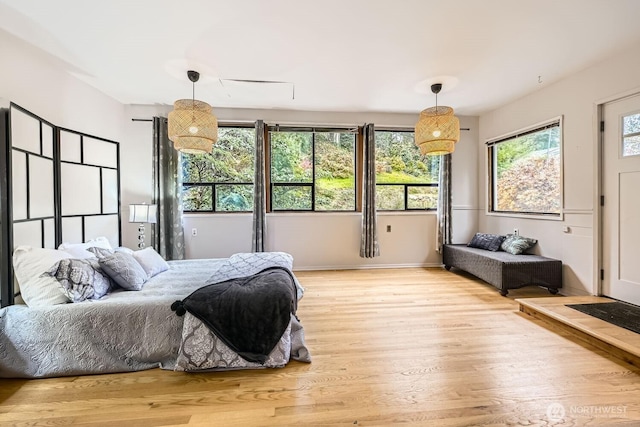 bedroom with light wood-style floors and baseboards