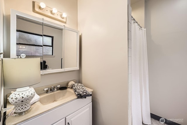 bathroom featuring vanity and curtained shower