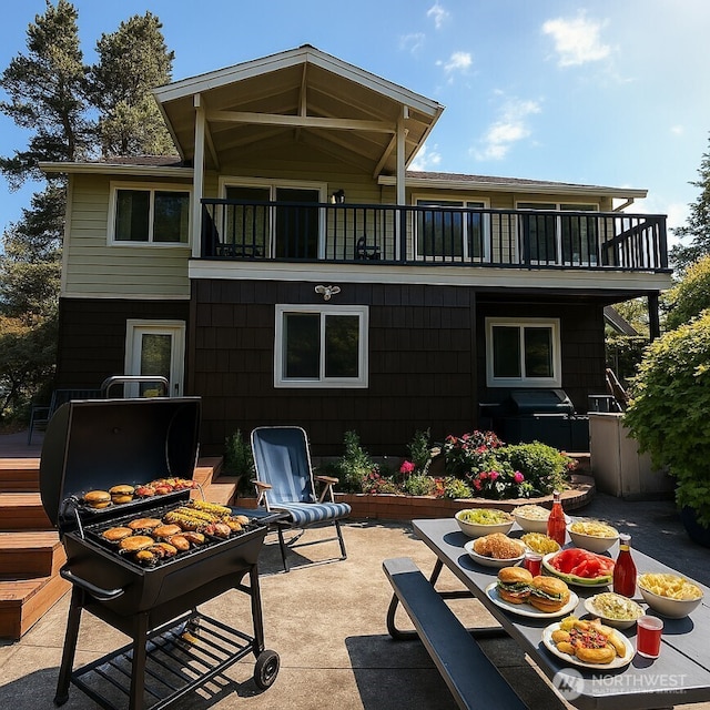rear view of property with a patio and a balcony