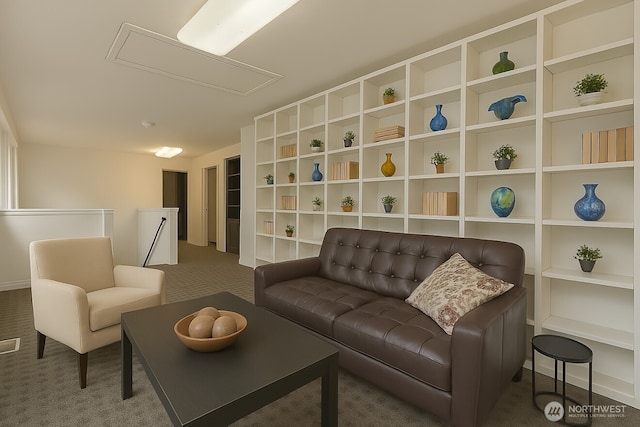 living area with attic access and carpet flooring