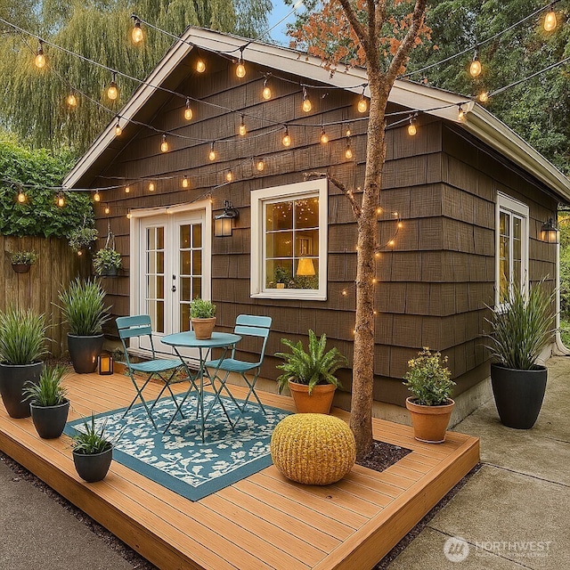 view of outdoor structure featuring french doors and outdoor dining space