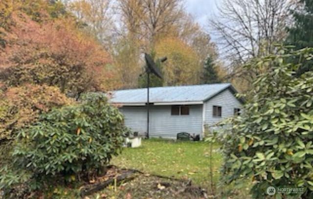 exterior space with an outbuilding and a yard
