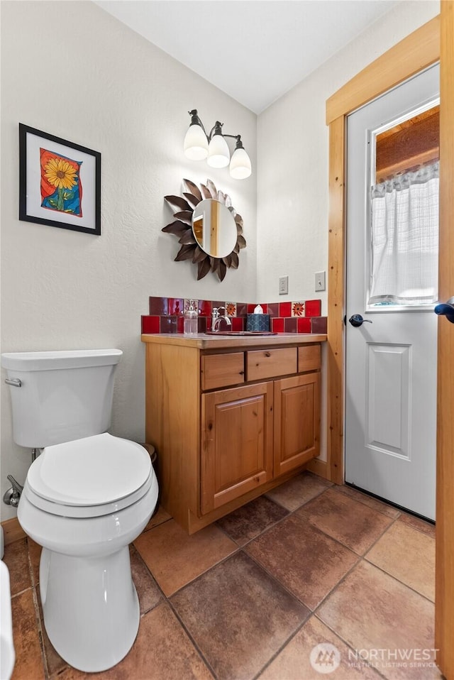 bathroom featuring vanity, tile patterned flooring, and toilet