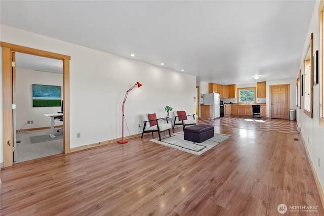 living room featuring beverage cooler, baseboards, and light wood-type flooring