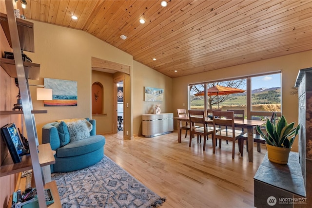 dining area featuring arched walkways, recessed lighting, wood finished floors, vaulted ceiling, and wood ceiling