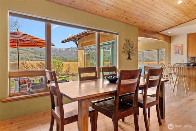 dining space with recessed lighting, wooden ceiling, light wood-type flooring, and a mountain view