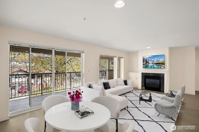 living room with a fireplace, wood finished floors, and recessed lighting