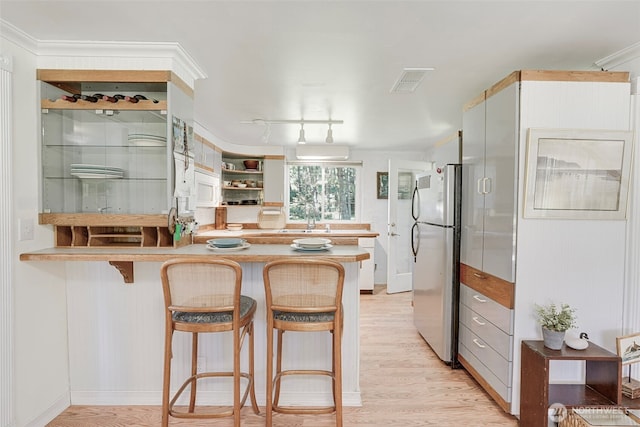 1506 163rd Pl, Long Beach, WA 98631 - kitchen featuring freestanding refrigerator, visible vents, light wood-style flooring, and white microwave