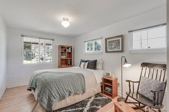 1506 163rd Pl, Long Beach, WA 98631 - bedroom featuring brick wall and wood finished floors