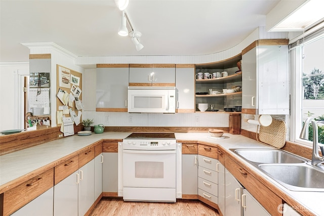 1506 163rd Pl, Long Beach, WA 98631 - kitchen featuring a sink, open shelves, a healthy amount of sunlight, white appliances, and light countertops
