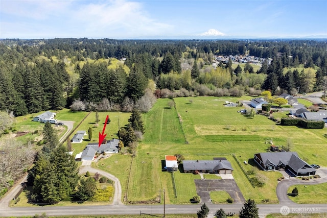 drone / aerial view featuring a forest view