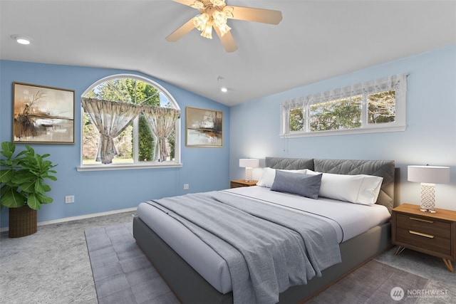 bedroom featuring carpet floors, ceiling fan, multiple windows, and lofted ceiling