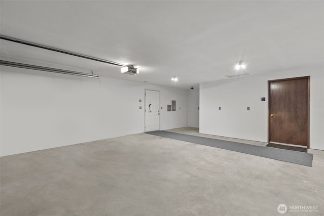garage featuring a garage door opener and electric panel