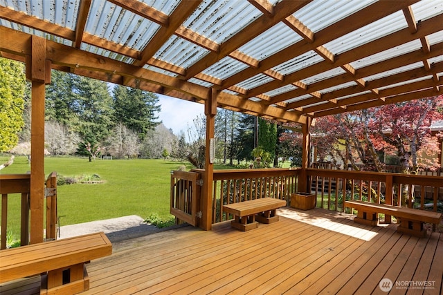 deck featuring a pergola and a yard