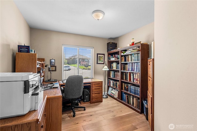 home office with light wood-style flooring
