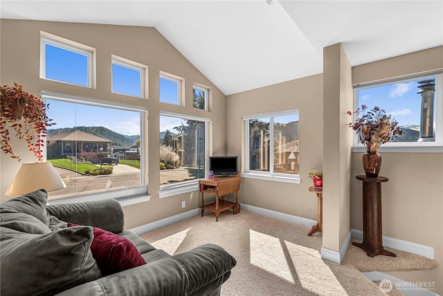 sitting room with high vaulted ceiling, carpet floors, and baseboards