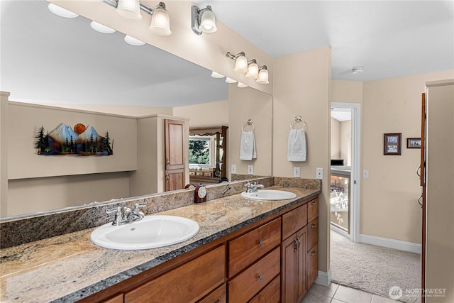 full bathroom with tile patterned floors, baseboards, a sink, and double vanity