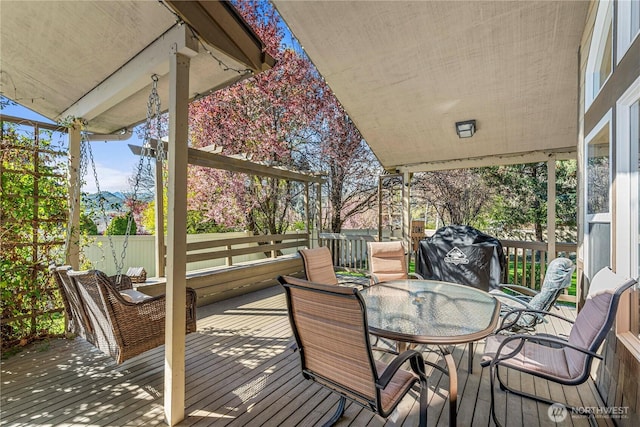wooden terrace featuring outdoor dining area