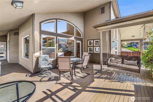 wooden terrace featuring outdoor dining space