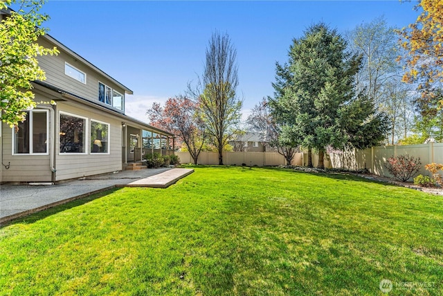 view of yard with a patio area and a fenced backyard