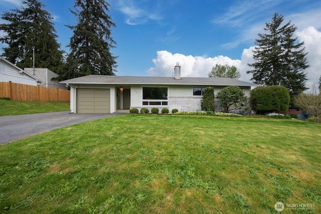 ranch-style house featuring a garage, aphalt driveway, fence, a front yard, and a chimney