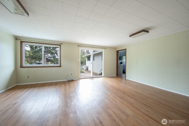 empty room with baseboards and wood finished floors